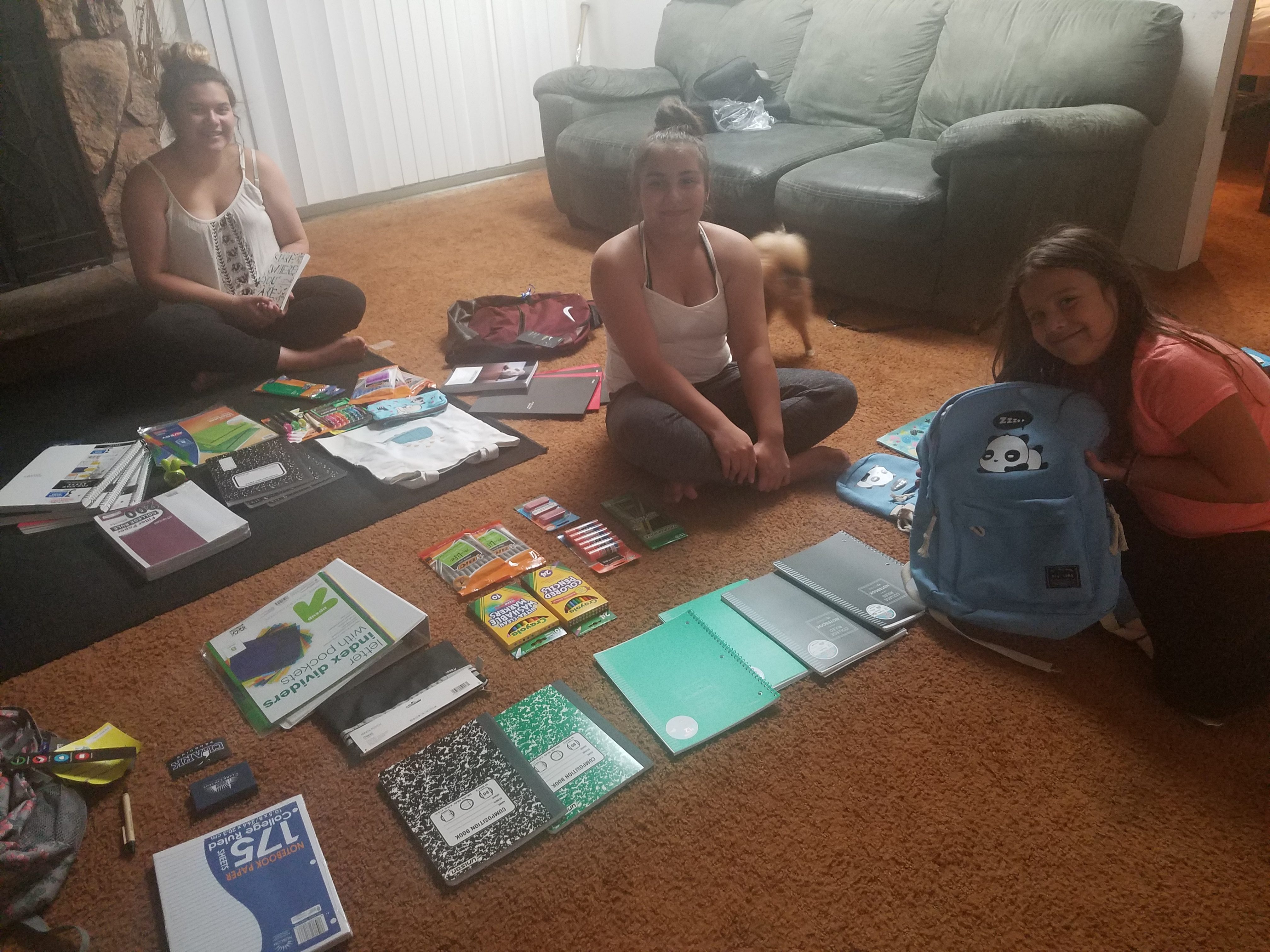 kids in house with backpacks and school supplies