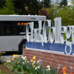 C-TRAN bus driving past Clark College campus sign