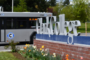 C-TRAN bus driving past Clark College campus sign
