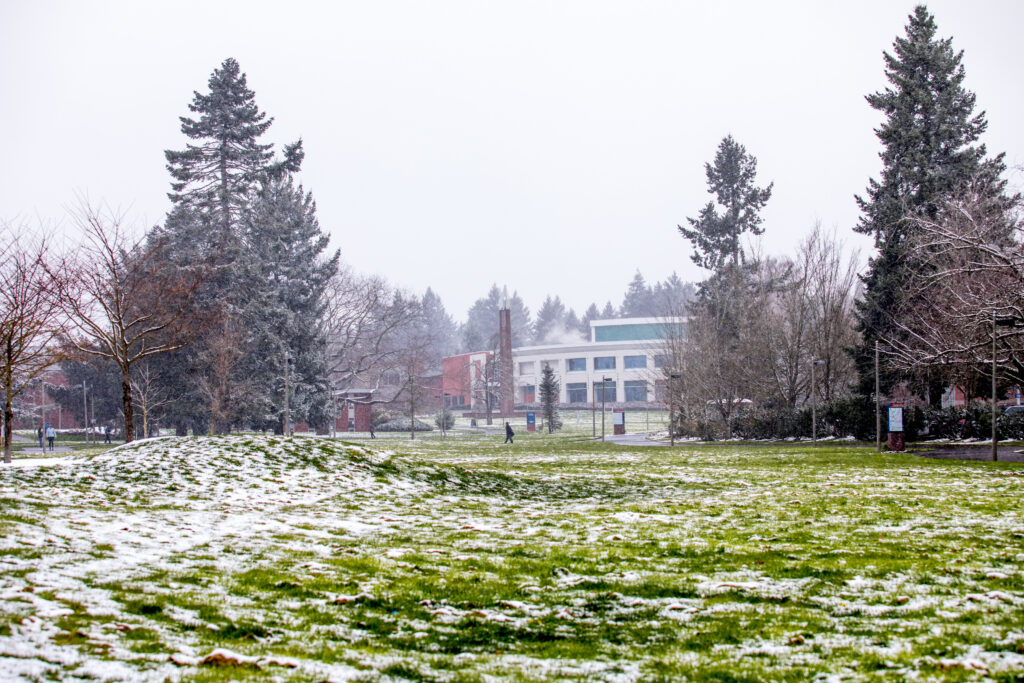 Clark College's main campus, dusted with snow, and students walking on pathways