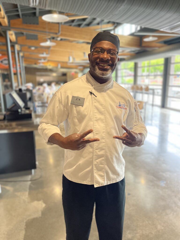 Chef Earl smiling in his chef uniform.