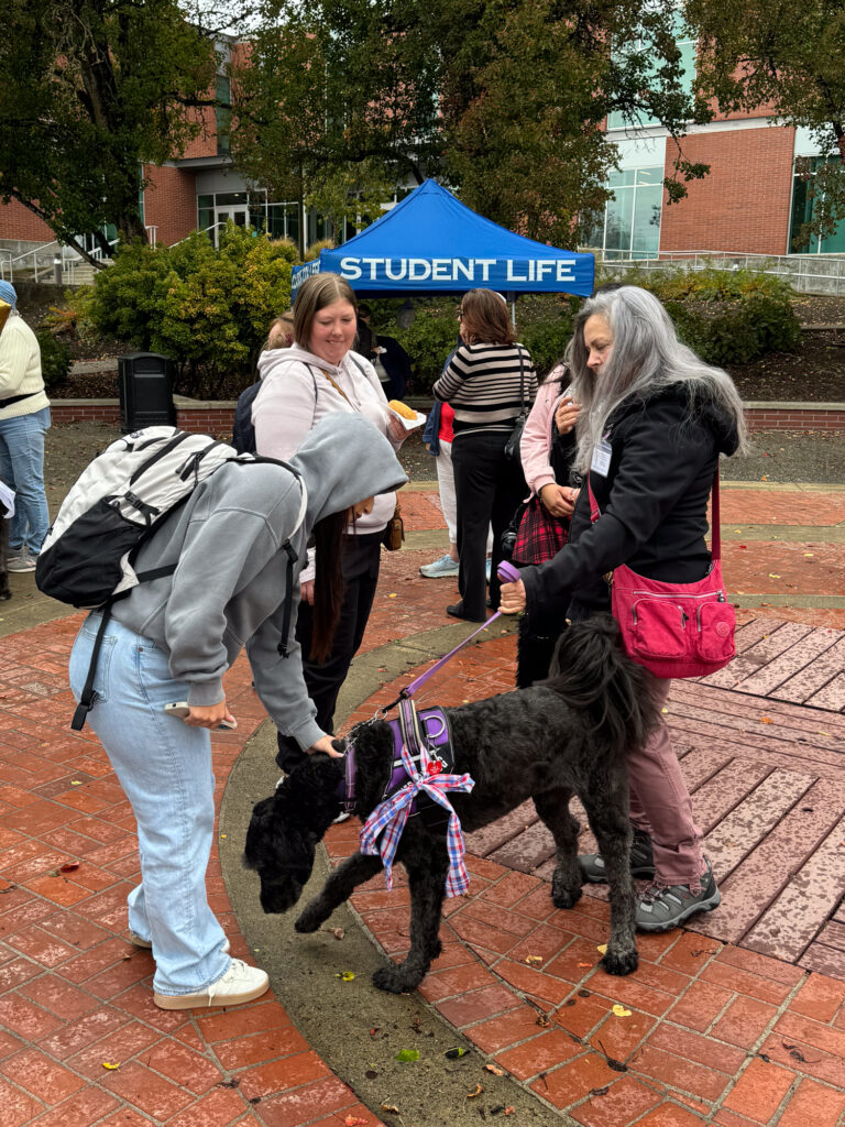 three people with dog