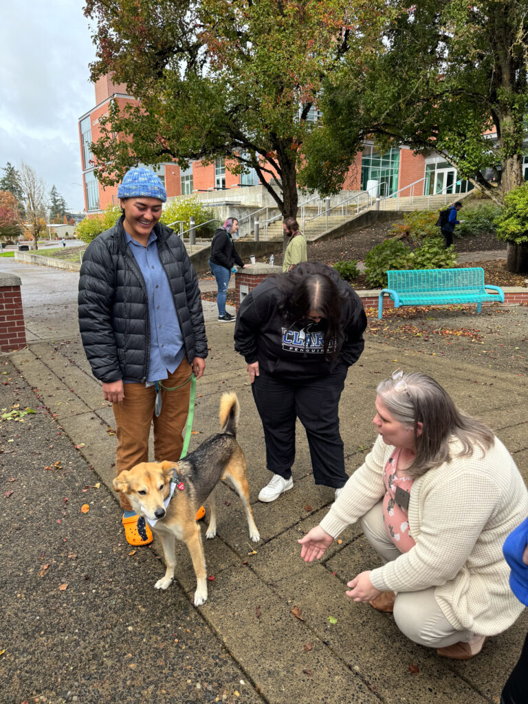 three people with dog