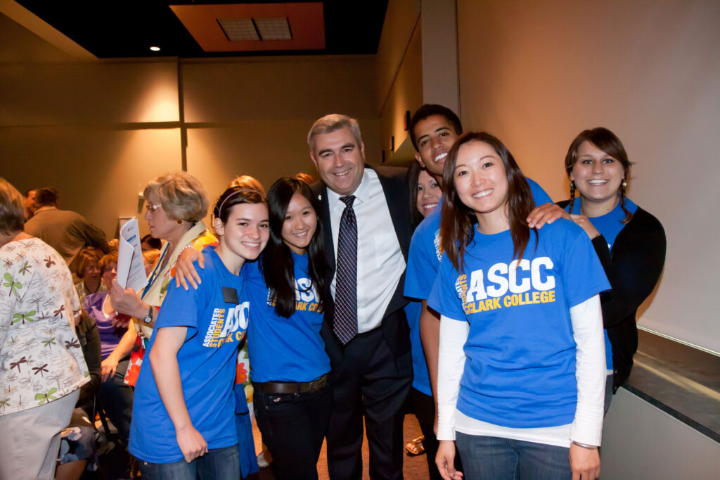 Former Clark College president standing with students.