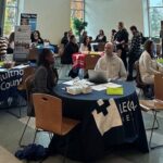 A career event with many people seated at tables.