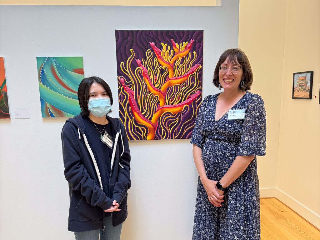 two people in front of artwork