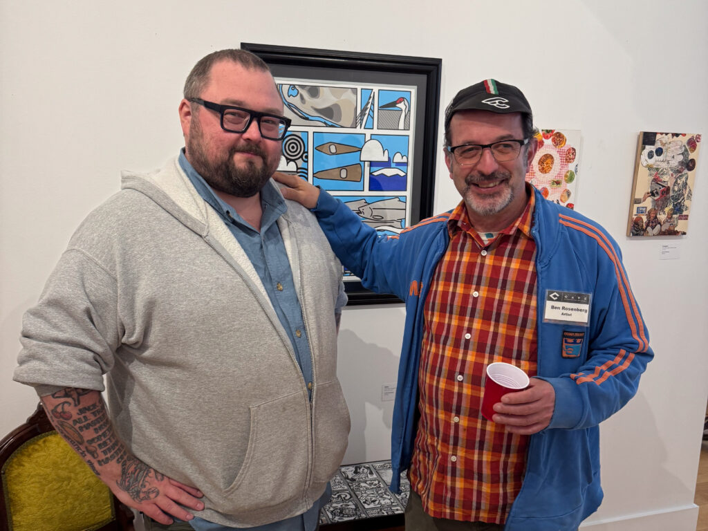 two people in front of artwork