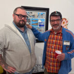 two people in front of artwork