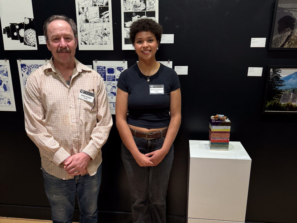 two people in front of artwork