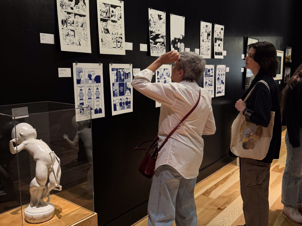 two people in front of artwork