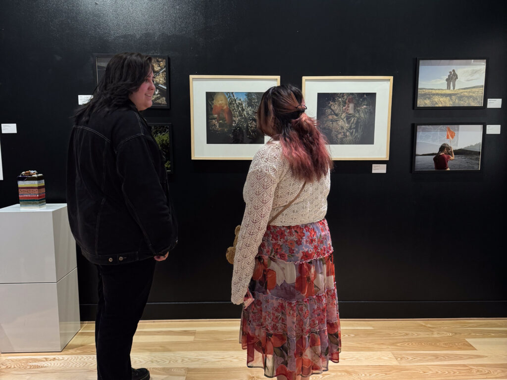 two people in front of artwork