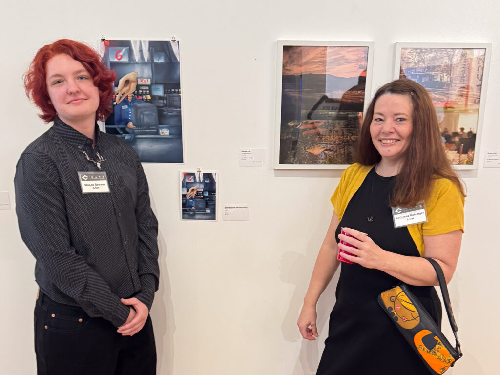 two people in front of artwork