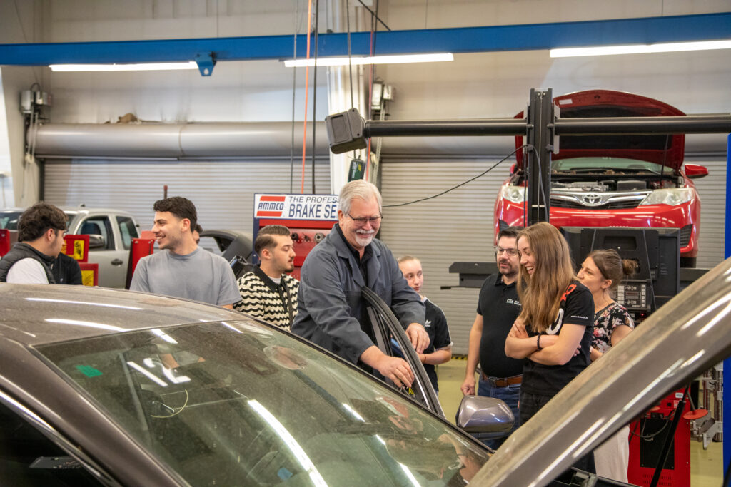 students stand around a car