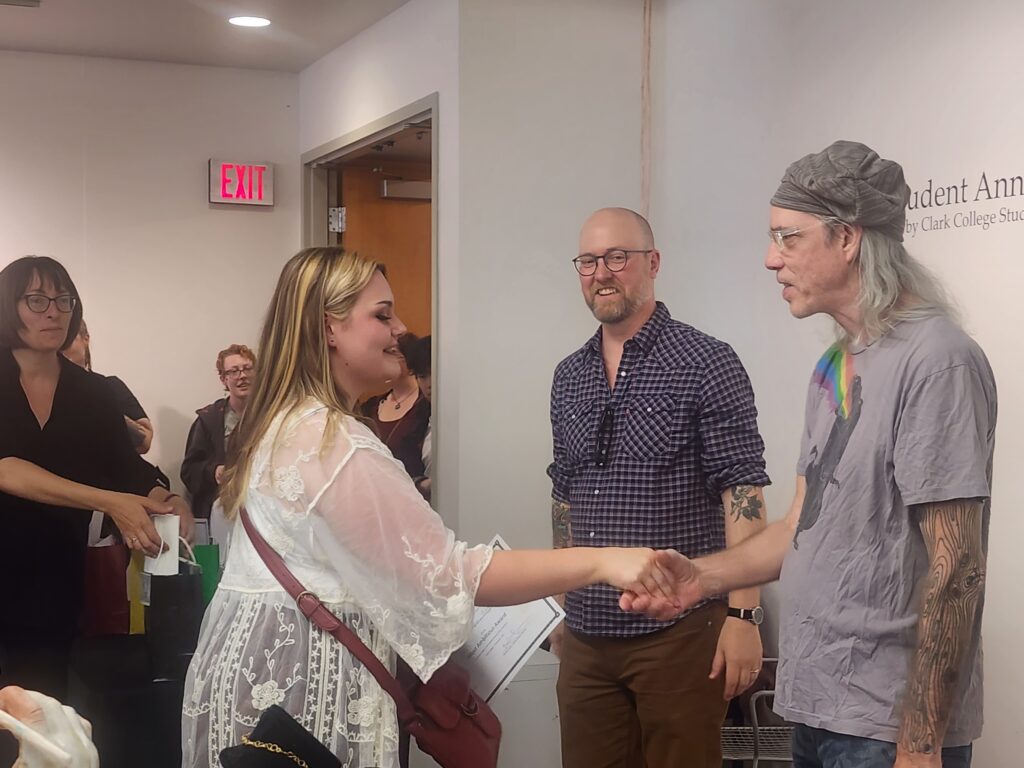 two people shaking hands in a crowd