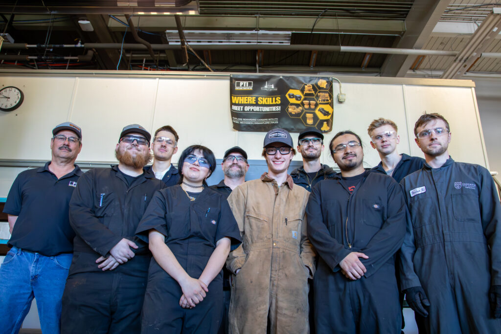 large group of people with protective eye gear and work wear.