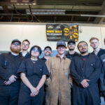 large group of people with protective eye gear and work wear.