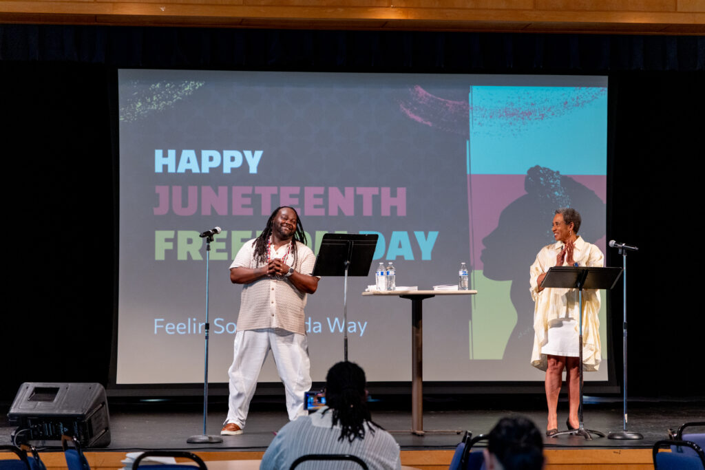 two people stand on stage