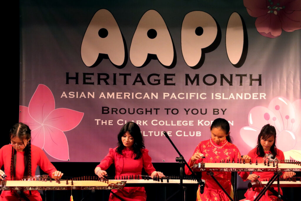 4 people on stage playing instruments