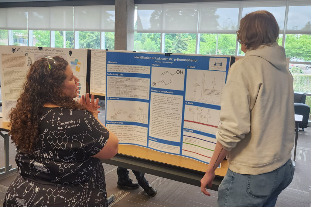 two people face a poster presentation.