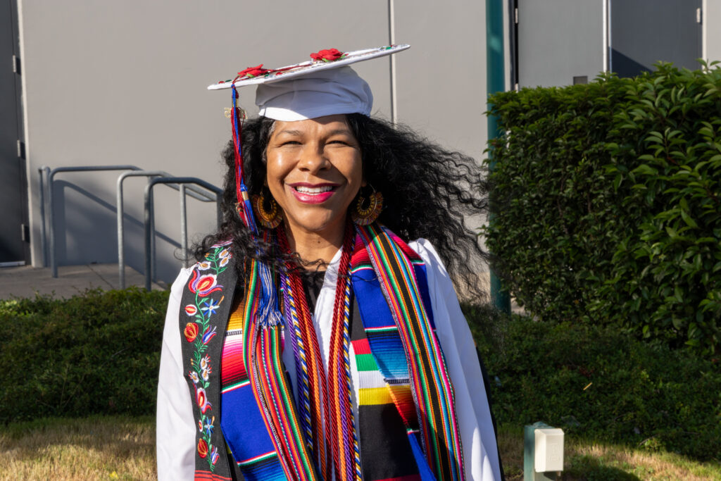 person in cap and gown with lots of stoles