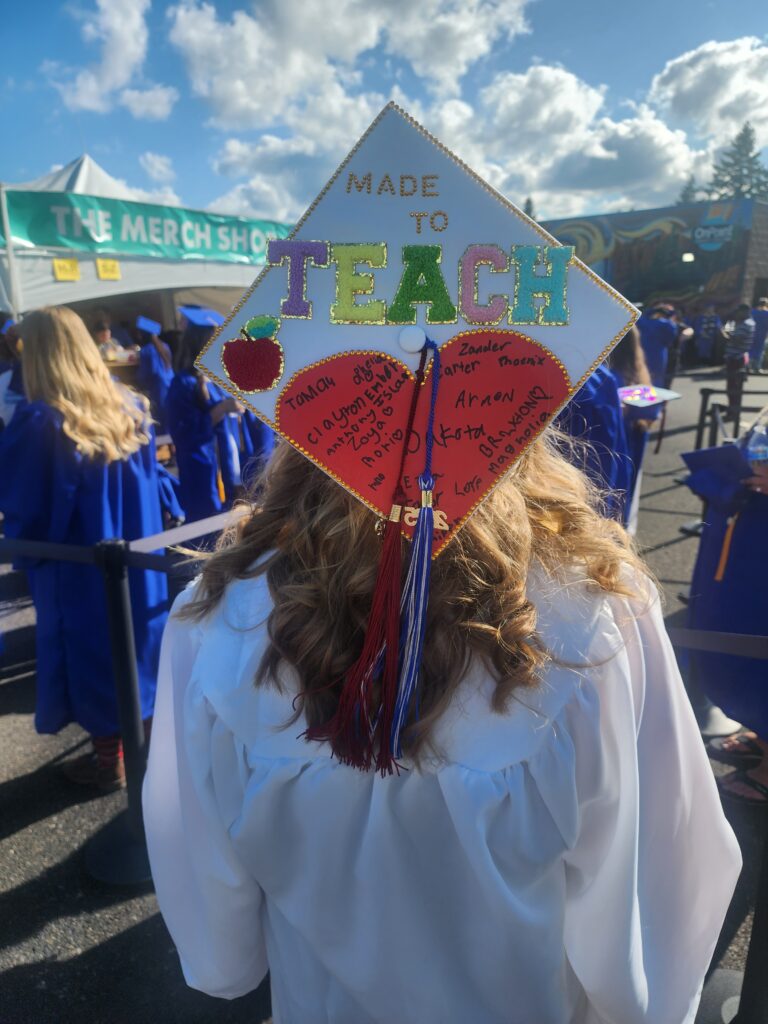 back of cap that reads made to teach