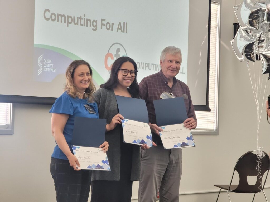 three people stand with certificates